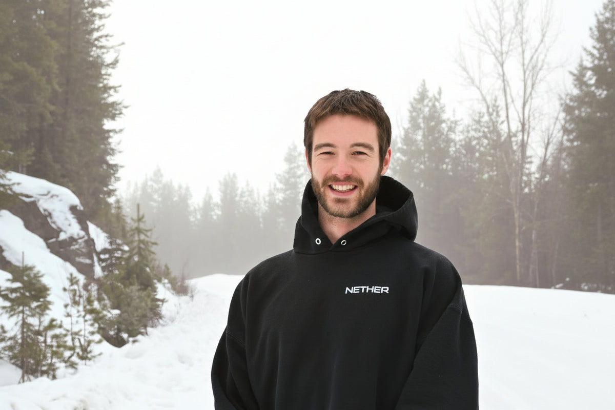 Stephen Hiscock wearing a black hoodie with 'Nether' logo in a snowy landscape